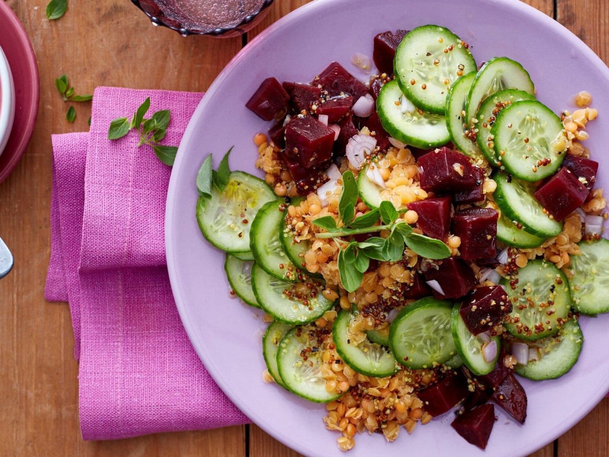 Rote-Bete-Linsensalat mit frischen Gurkenscheiben, süßem Senf, Zwiebeln und frischem Oregano