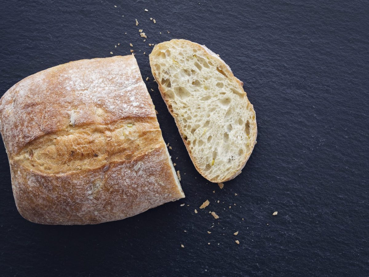 E171 nicht sicher: ein aufgeschnittenes Weißbrot auf dunklem Untergrund