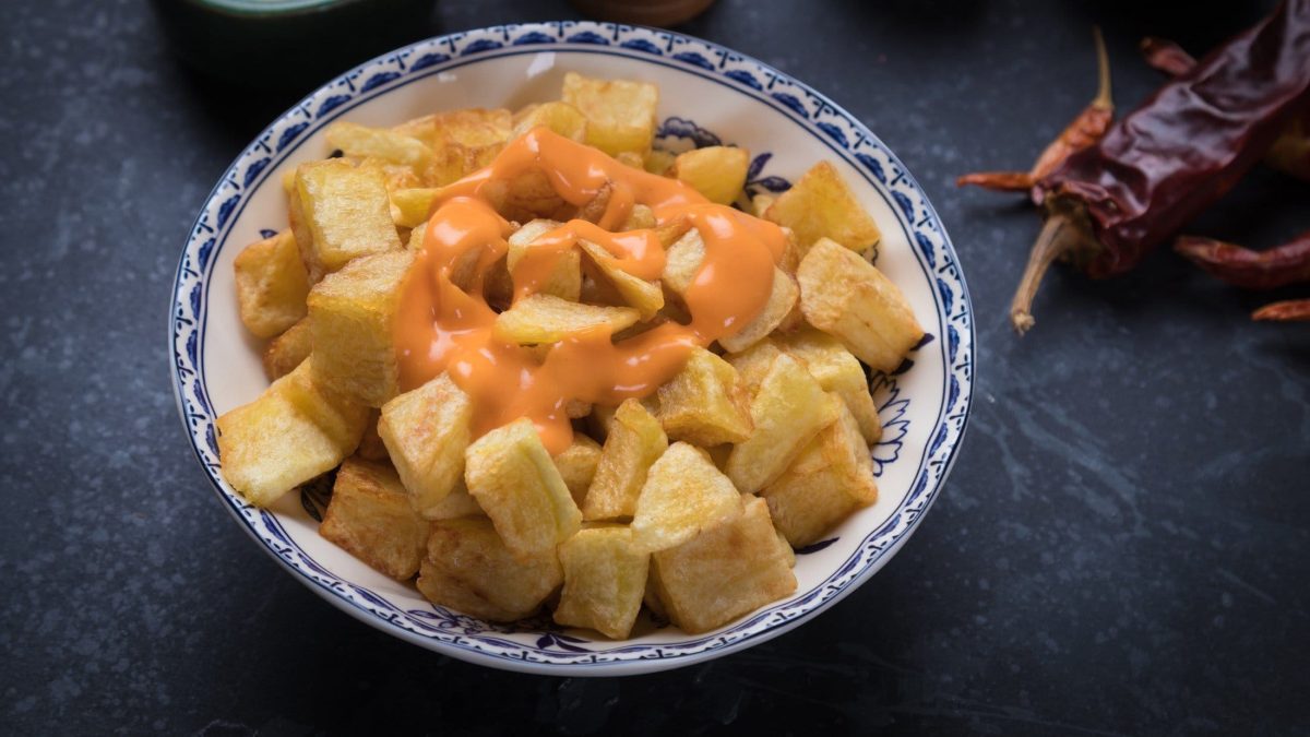 Patatas bravas mit Dip auf dunklem Untergrund