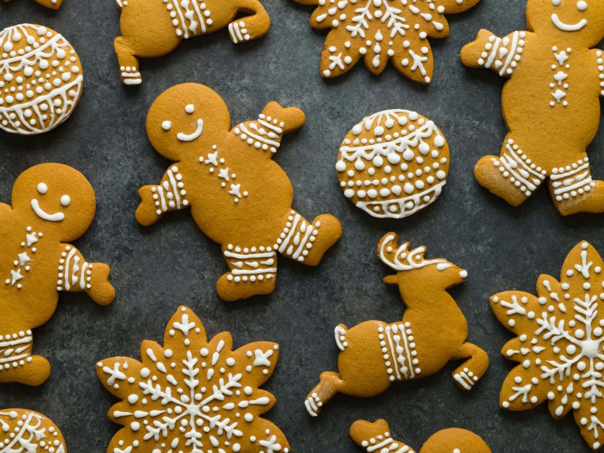 Verschiedene selbstgemachte Lebkuchen auf schwarzem Untergrund. Verziert mit weißem Zuckerguss.