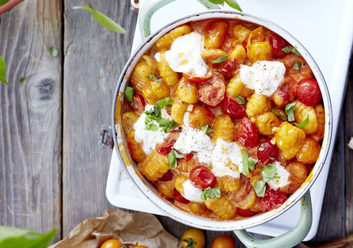 Gnocchi mit geschmolzenem Käse in Tomatensauce in einem Topf