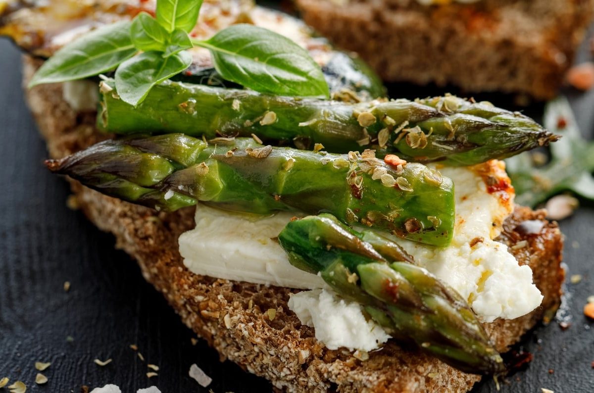 Vegane Spargel-Bruschetta mit Frischkäse, Basilikum und Pfeffer.