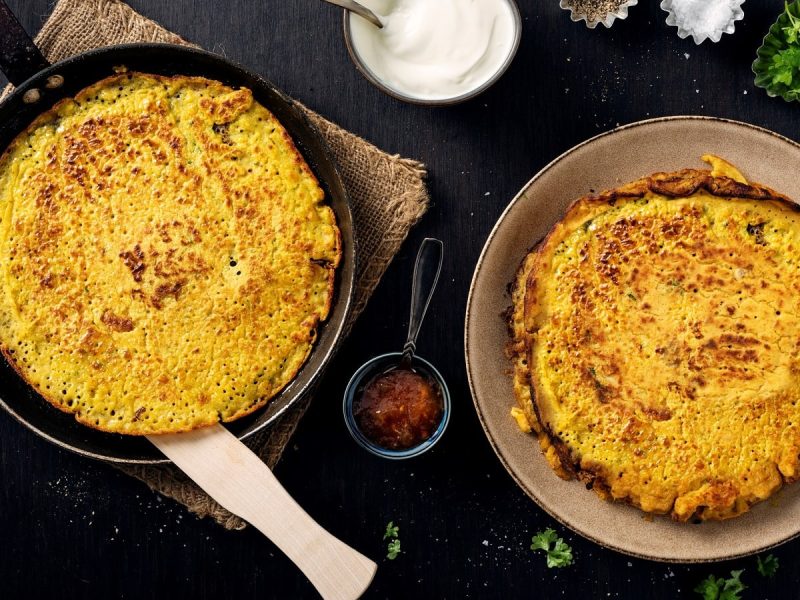 Eine Pfanne und ein Teller mit Rote-Linsen-Pfannkuchen