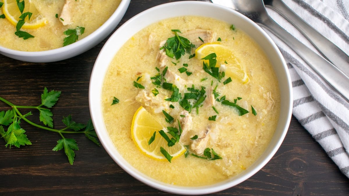 Eine Schüssel mit Avgolemono auf einem Holztisch.