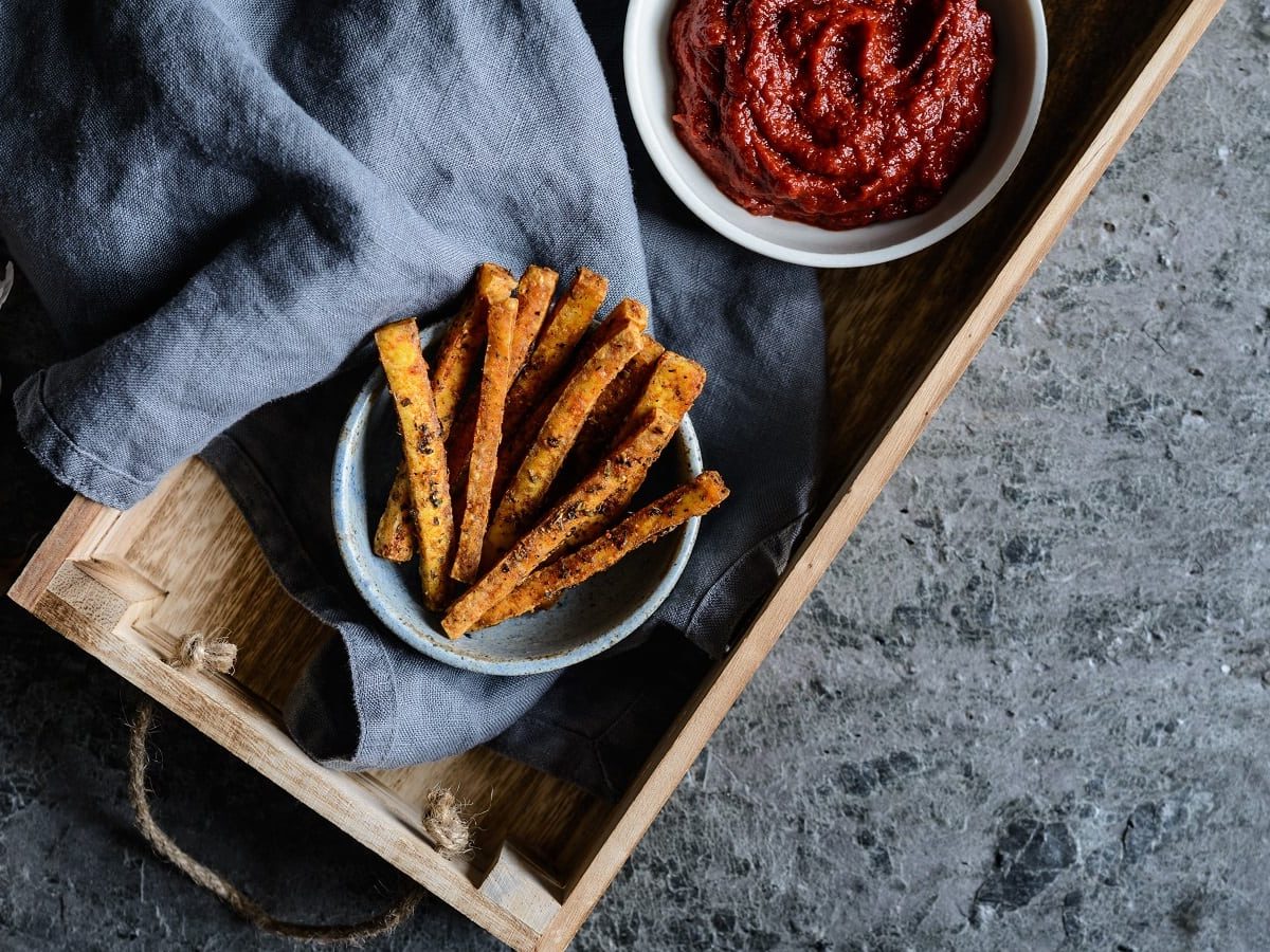 Ein Holztablett mit Tofu Fries darauf.