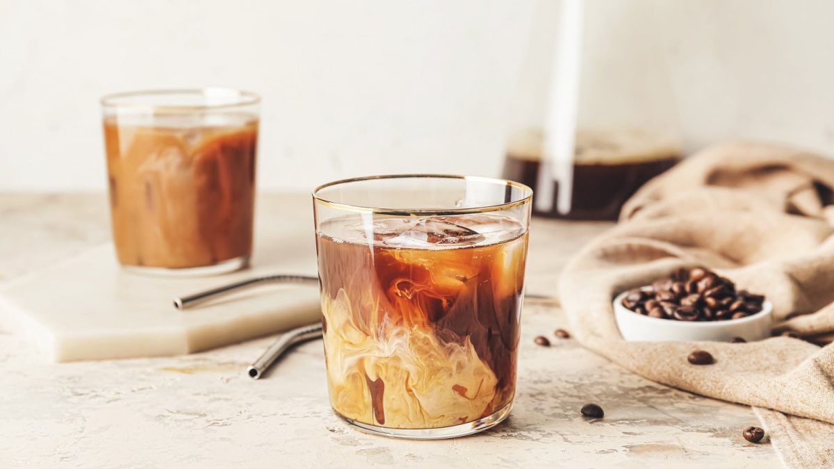 Ein Glas mit Vanilla Cold Brew Coffee auf einem hellen Tisch.