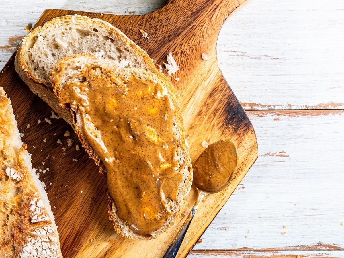 Ein Brot mit Spekulatius-Aufstrich auf einem Holzbrett.