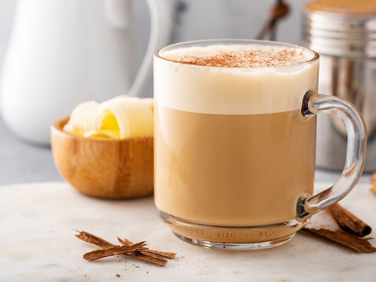 Eine Tasse Kokos-Zimt-Latte auf einem hellen Untergrund.