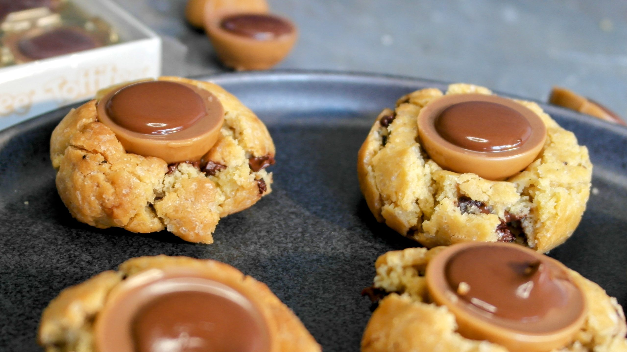 Die Toffifee-Cookies auf einem dunklen Teller in der Nahansicht, mit einer Packung Toffifee im Hintergrund.